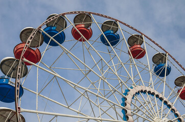 Ferris wheel over blue sky. Ferris wheel idle without work