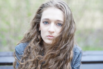 Portrait of a young beautiful girl in the park