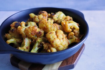 Gobi or Gobhi Tandoori. Masala Roasted cauliflower is a popular Indian vegetarian starter dish served with mint and coriander chutney. copy space.