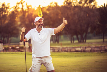 Happy senior golfer with thumb up.