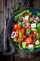 Greek salad made of lettuce, feta cheese nd cherry tomatoes.