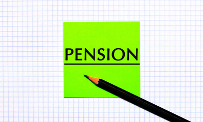 There is a green sticker with the text PENSION and a black pencil on the checkered paper.