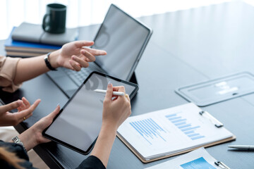 Close-up of a businesswoman meeting hand holding  tablet graph on the table at the office.