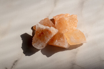 Himalayan Pink rock Salt on marble background. Interior decoration