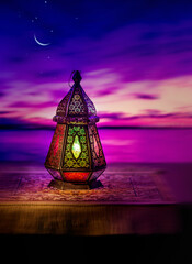 Beautiful Eid moon in the evening sky with an illuminated Egyptian lantern on the foreground. Ramadan greeting card photo with clear space for text. © Telsa