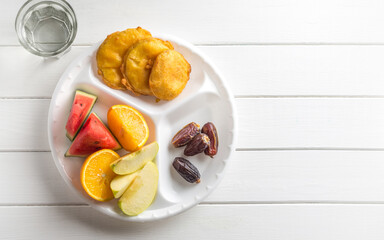 Bhajiya, fruits and dates are served in a disposable plate for Iftar ritual . Food is distributed to poor people during holy month of Ramadan.