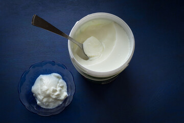 Creamy and nutritious yogurt is served in a bowl from the tub. Yoghurt is an essential dairy product in the diet for nutrients. 