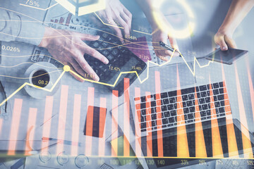 Double exposure of man and woman working together and financial chart hologram drawing. market...