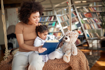 Afro american mother reading bedtime story