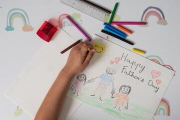 Girls' hands making hand drawings and cards for Father's Day