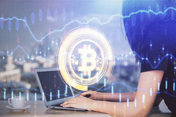 Double exposure of woman hands typing on computer and crypto market theme hologram drawing....