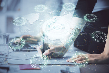 Double exposure of woman hands typing on computer and social network theme hologram drawing. People...
