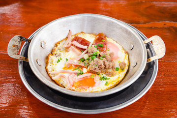 Fried eggs served on pan.