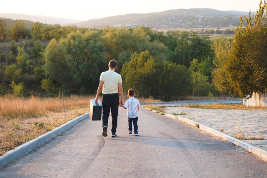 father and son walking away