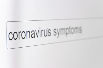 Search bar on a computer monitor with the question Coronavirus symptoms. Searching for information on the Internet, close up.