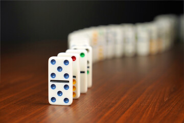 Dominos falling or domino effect.  Conceptual image.