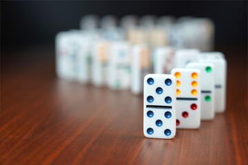 Dominos falling or domino effect.  Conceptual image.