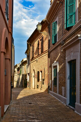 A narrow street between the old houses of Civitanova Alta, a medieval town in the Marche region of Italy.