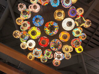 Turkish pendant multi-colored glass lamps hang from the ceiling.