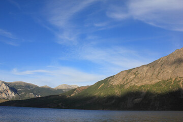 incredible view on lake called windy arm, and surrounding mountains in canadian wilderness, path...