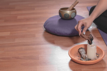 Young woman with incense and Tibetan singing bowl