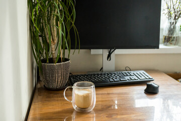 Home office interior with laptop and cup of coffee