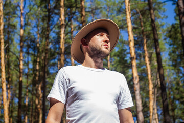 Obraz premium Man with a hat in the forest. Hike in the mountains, forest