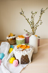 Glazed easter cake decorated with oranges and eggs on wooden table. Happy Easter Holidays