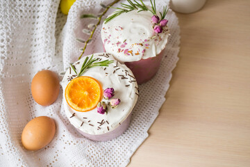 Glazed easter cake decorated with oranges and eggs on wooden table. Happy Easter Holidays