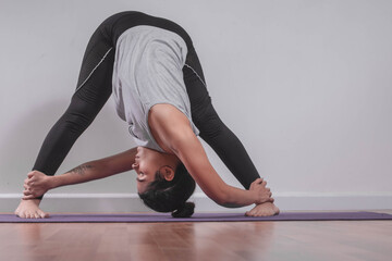 Young woman practicing yoga in studio