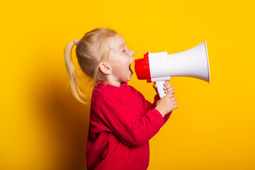 child shouts into a white megaphone on a bright yellow background