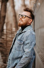 portrait of a man with a red beard and glasses