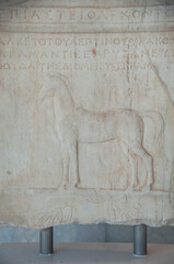 Section of an ancient marble frieze in a museum in Athens, Greece