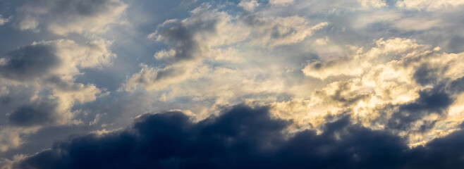 Fototapeta na wymiar Dark storm clouds in a dramatic sky before sunset