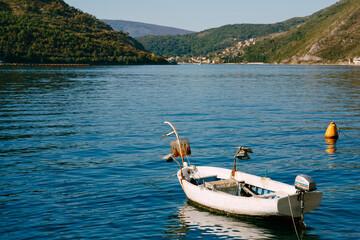 Fototapeta na wymiar Small wooden boat with a searchlight in the Bay of Kotor.