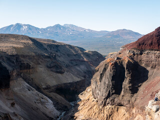 View of the Opasny canyon near the Mutnovsky volcano. The depth of the canyon surprises with its scale and incredible views of the volcanoes. Kamchatka Peninsula, Russia.