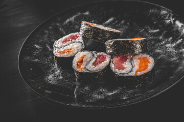 Yin yang sushi roll with tuna and salmon on plate