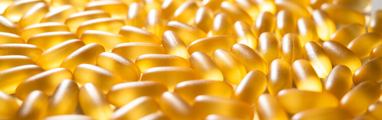 Close-up of golden omega three capsules. Dietary supplement fish oil