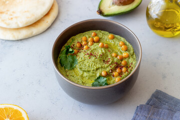 Avocado hummus in a gray bowl. Healthy eating. Vegetarian food.