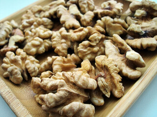 Walnuts lie on wooden plate