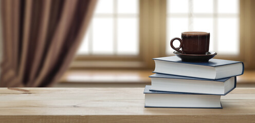 Fototapeta premium stack book and cup of coffee on wooden table