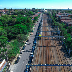 Drone Aerial view of a train tracks in an inner suburb of Sydney with views of residential houses...
