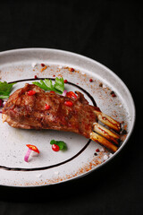 grilled meat on the bone ribs closeup on ceramic plate