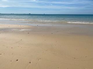 Fototapeta na wymiar low tide on sunny golden beach