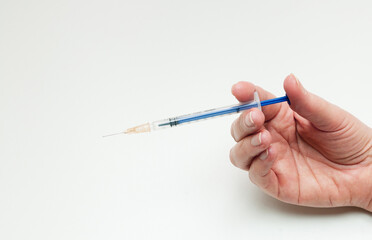 hand with syringe on white background
