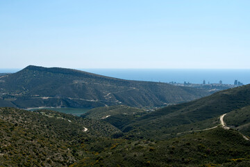 Scenic view of green mountains, Germasogeia water reservoir, Mediterranean sea and Limassol city, Cyprus 