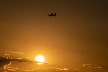 Hydroplane silhouette at sunset with orange sky