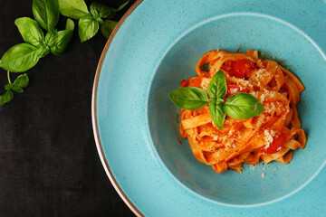 marinara pasta with basil leaf on dark background top view. Spaghetti with tomato sauce and basil top view