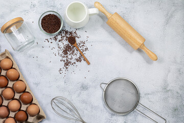 Preparation of the dough. A measurement of the amount of ingredients in the recipe. Ingredients for the dough: flour, eggs, rolling pin, whisk, milk, butter, cream. Top view, space for text 