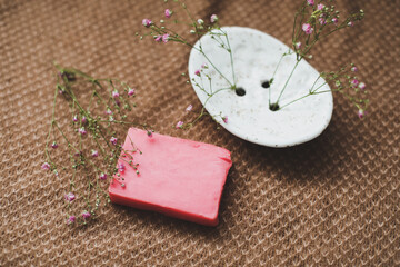 Natural handmade soap bar with ceramic soap dish and flowers, spa organic soap, sustainable lifestyle